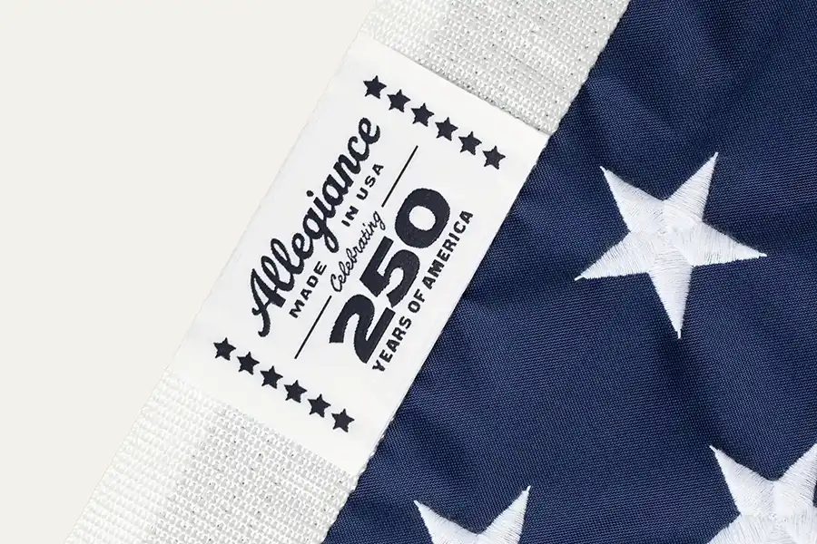 Close-up showing embroidered stars, and reinforced heading of a high-quality American flag